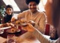 Close-up of Islamic family eating baklava at dining table at home.