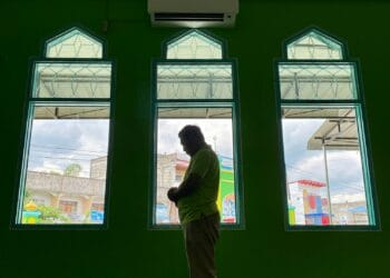 Muslim asian man praying performing salah at the mosque