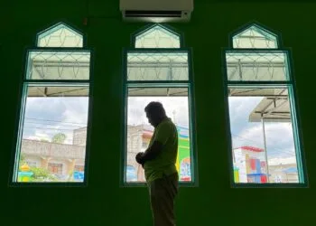 Muslim asian man praying performing salah at the mosque