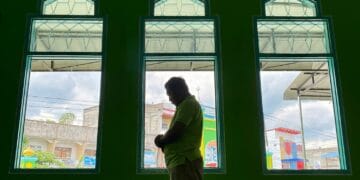 Muslim asian man praying performing salah at the mosque