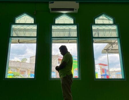Muslim asian man praying performing salah at the mosque